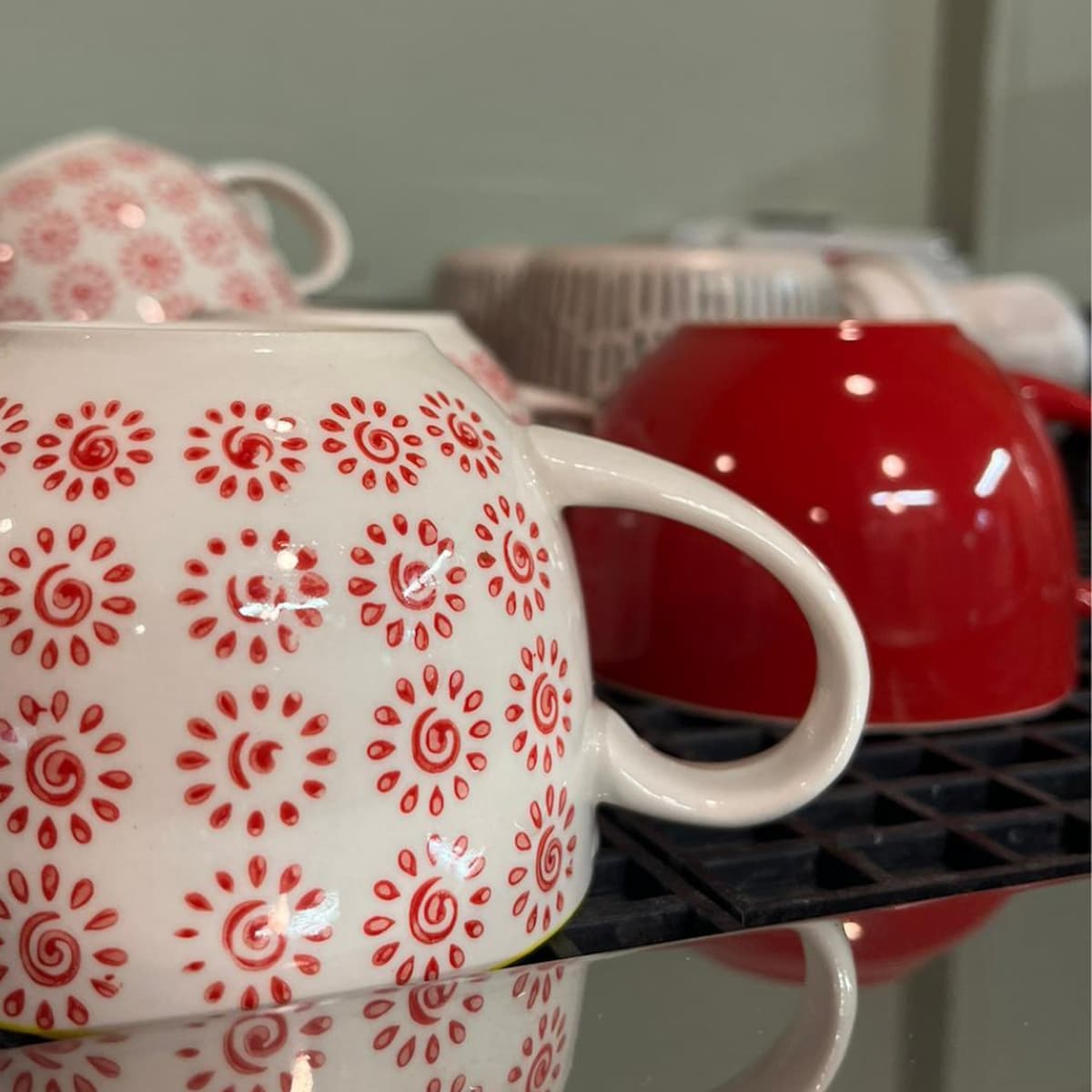 Clean red and white patterned coffee cups at Understated coffee shop.